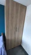 The Natural Pacific Walnut fitted wardrobe with doors closed, installed in Sunderland